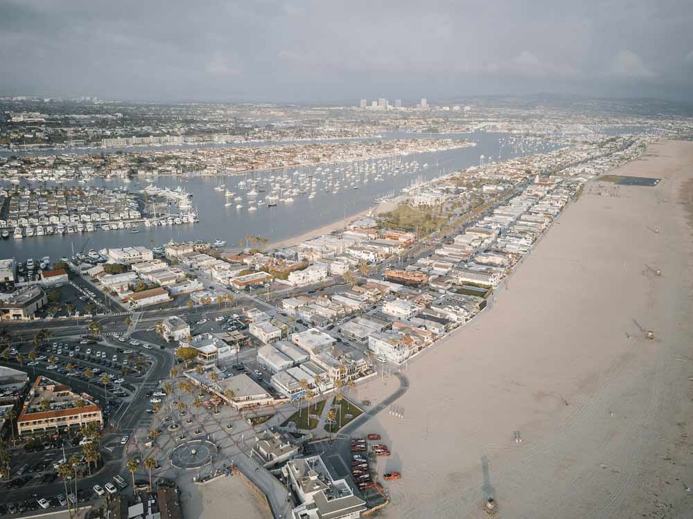 Aerial view of a harbor town along a wide beach