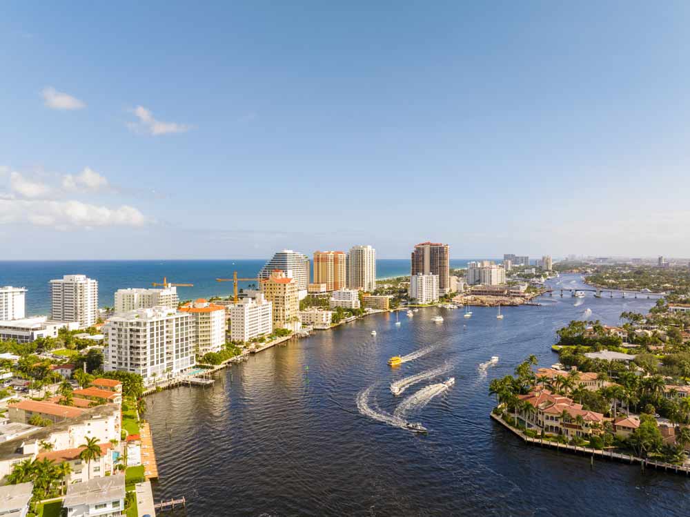 Aerial view of a waterway lined with high-rises and boats