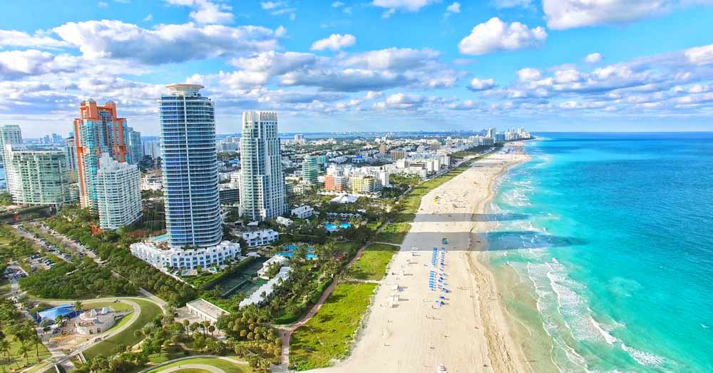 Aerial view of beachfront towers and turquoise water