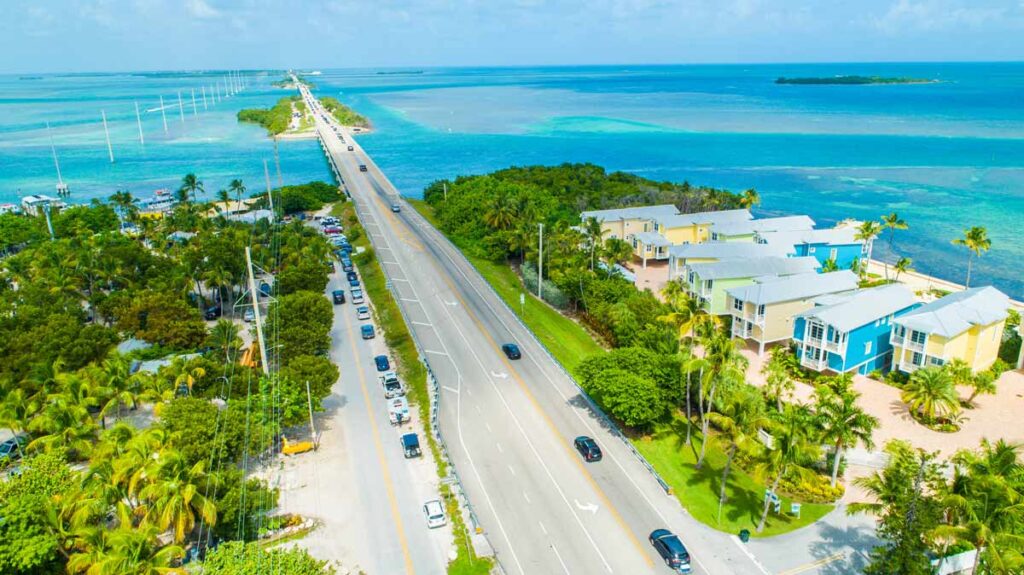 Aerial view of a road running along a tropical coastline