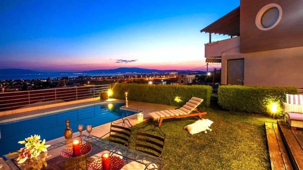 Hillside terrace with a pool and loungers at dusk