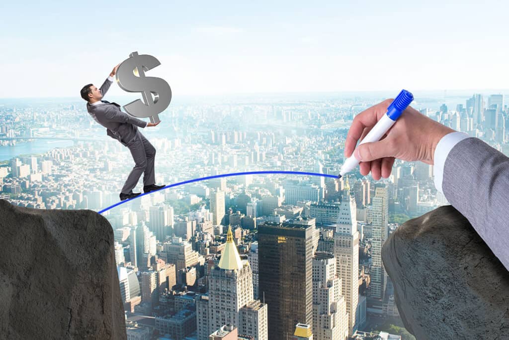 Illustration of a businessman carrying a dollar sign across a drawn bridge between cliffs