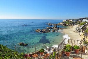 Rocky cove with clear blue water and cliffside homes