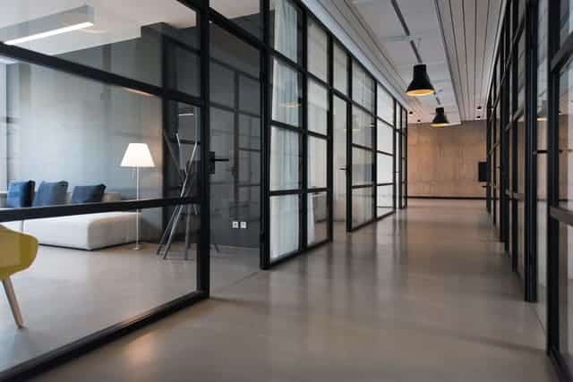 Empty modern office corridor with glass walls