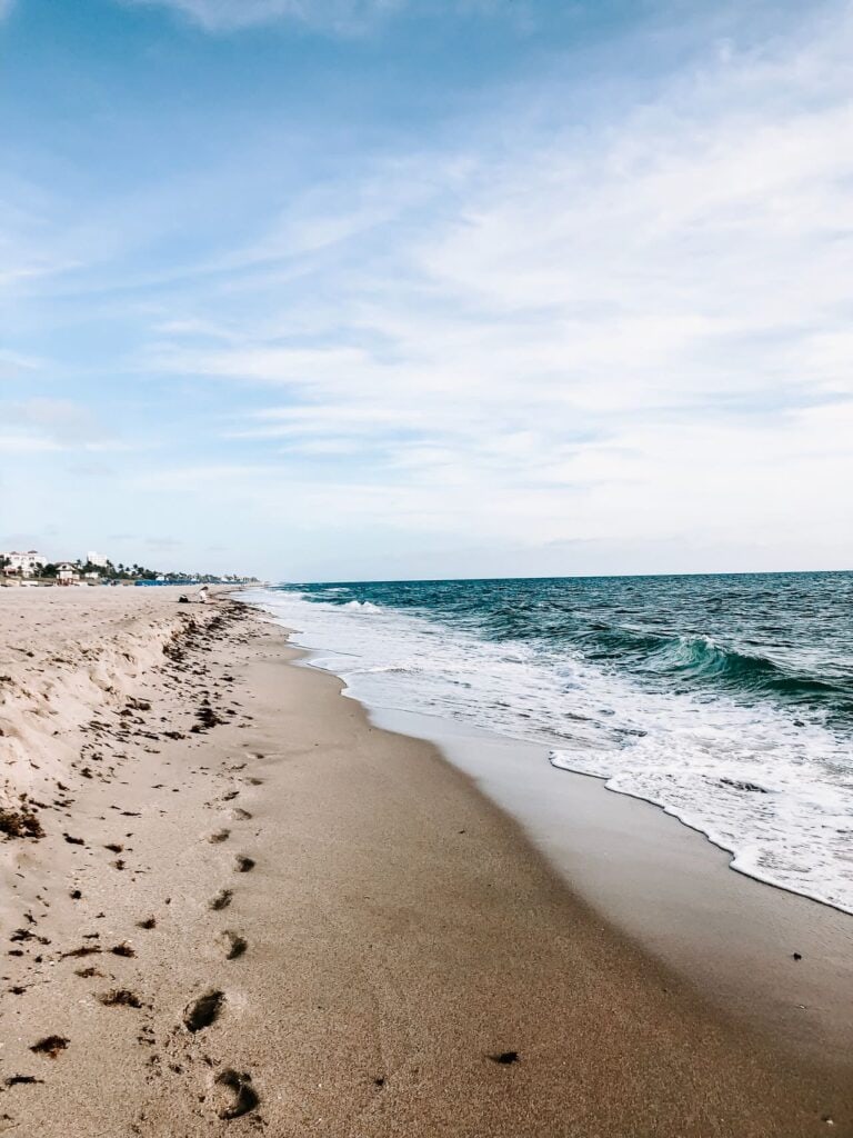 Sandy beach with waves and footprints