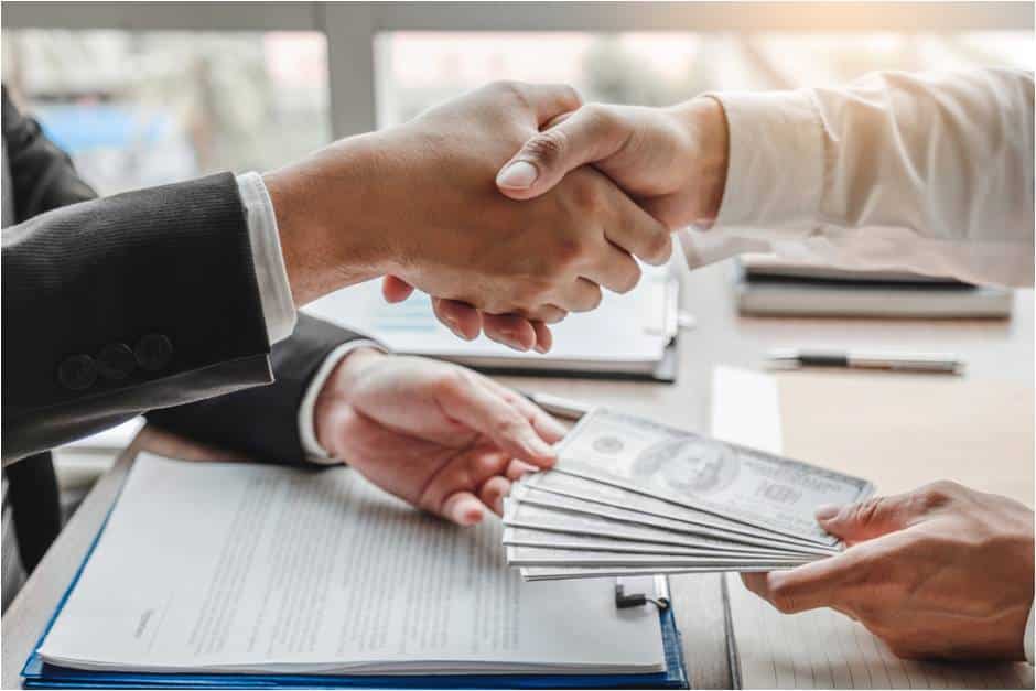 Handshake as cash changes hands over a contract